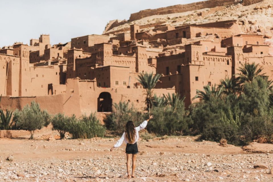 Woman enjoying popular landmark ksar Ait-Ben-Haddou. View from behind. Travel in Morocco, Ouarzazate. Wanderlust concept.