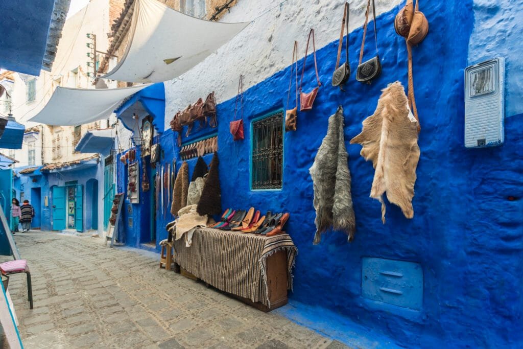 Blue street in Chefchaouen with traditional Moroccan souvenirs and handicrafts