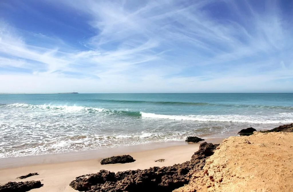 Beautiful sandy beach in Taghazout near Agadir, Morocco, popular for surfing and Atlantic coastal views.
