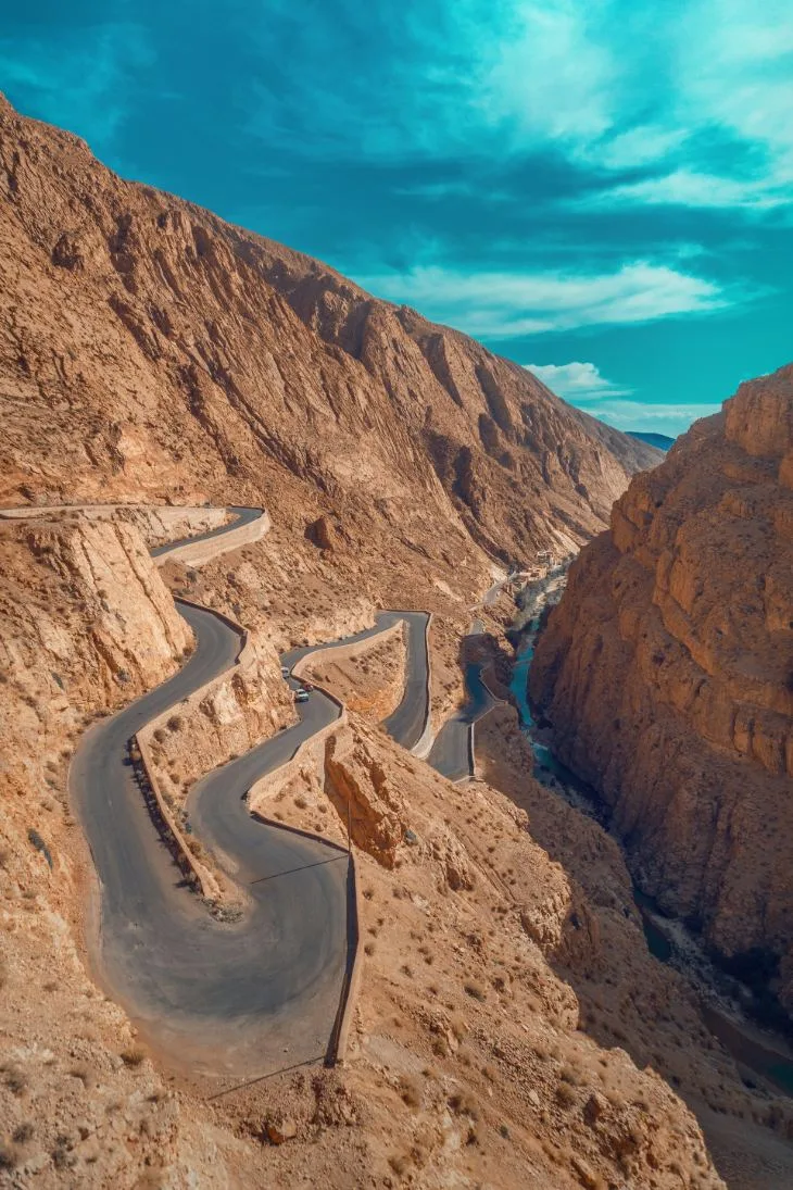 Winding mountain road through the dramatic landscapes of Dades Valley in Morocco.
