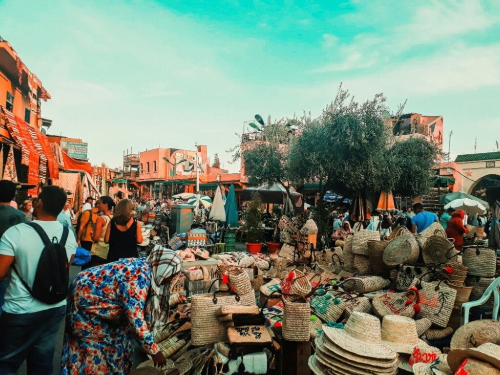 Colorful Marrakech souk market with traditional Moroccan baskets, hats, and handmade crafts in the medina