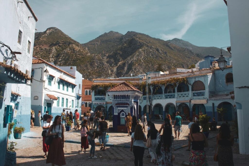Narrow winding streets and whitewashed buildings painted in vivid shades of blue in the medina of Chefchaouen, a iconic mountain town nestled in the Rif Mountains of northern Morocco.