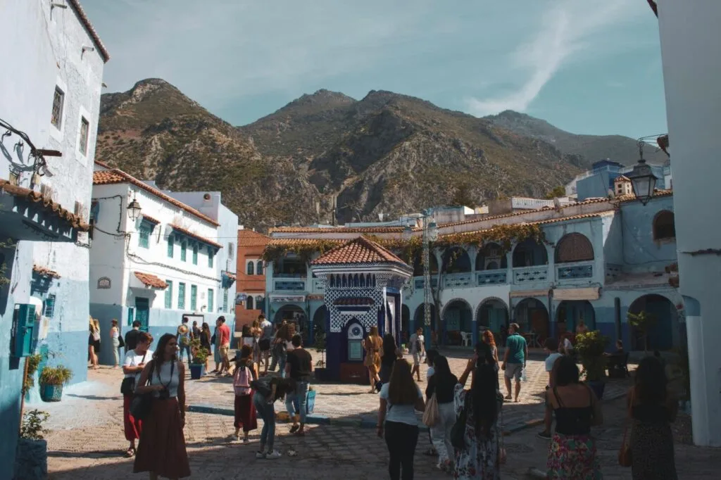 Narrow winding streets and whitewashed buildings painted in vivid shades of blue in the medina of Chefchaouen, a iconic mountain town nestled in the Rif Mountains of northern Morocco.
