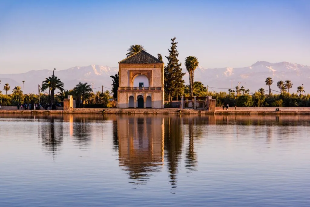 Historic Menara Gardens pavilion reflected in the water basin in Marrakech, Morocco.